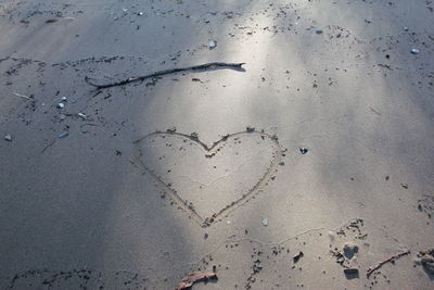 High angle view of heart shape on sand