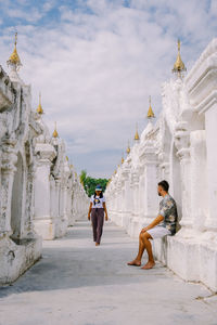 People at temple against building