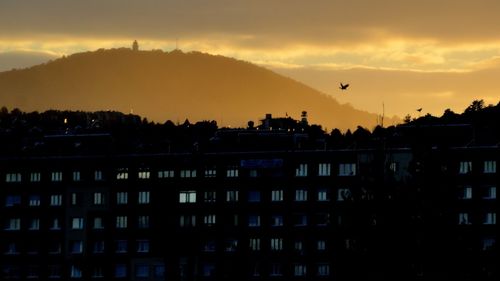 Buildings in city at sunset