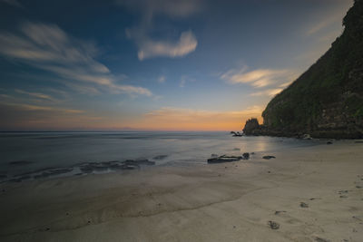 Scenic view of beach against sky during sunset