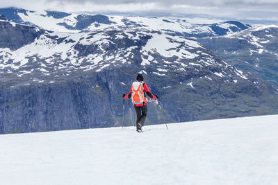 Rear view of woman on snowcapped mountains