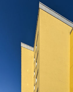 Low angle view of building against clear blue sky