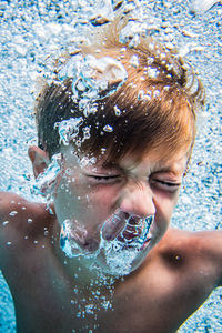 Close-up of man swimming in pool