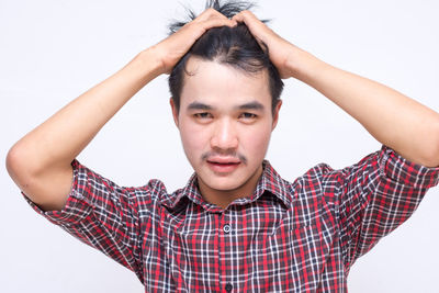 Portrait of young man against white background