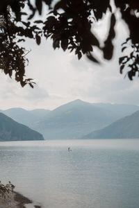 Silhouette of a man stand up paddling in a lake