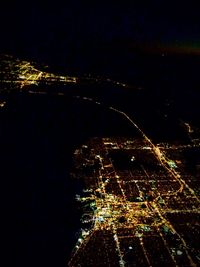 Aerial view of city lit up at night