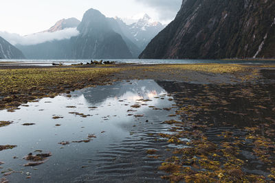 Scenic view of lake and mountains against sky