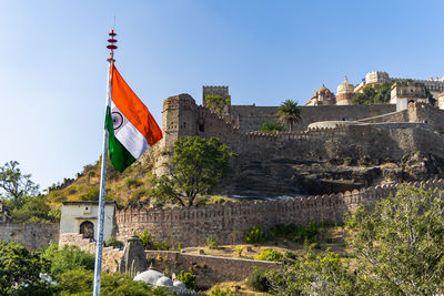 Indian tricolor waving at ancient fort from flat angle