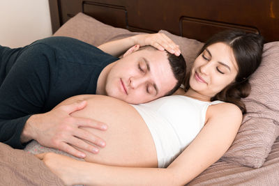 Young woman sleeping on bed at home