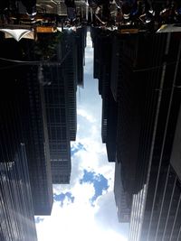 Reflection of city on cloudy sky