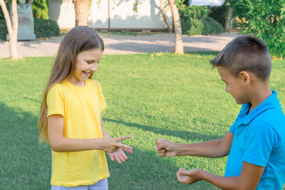 Two children, a boy and a girl, are playing in the park. childrens friendship.