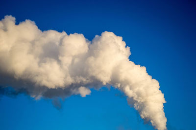 Smoke stack against clear blue sky