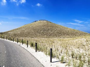 Scenic view of land against blue sky