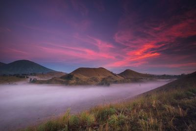 Scenic view of landscape against cloudy sky