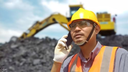 Portrait of man working at construction site