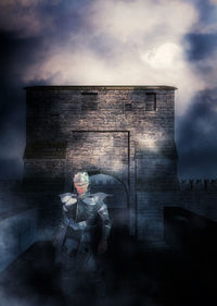 Digital composite image of man sitting against building