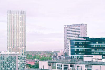 Modern buildings in city against sky