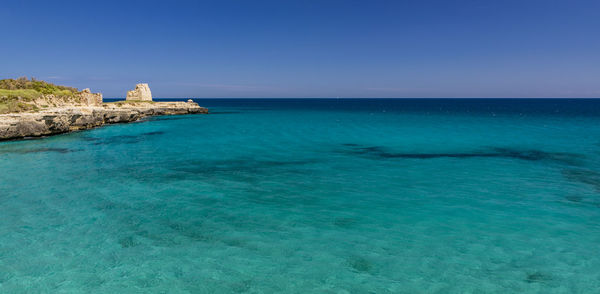 Scenic view of sea against clear blue sky