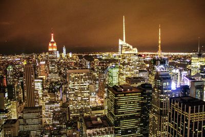 Aerial view of city lit up at night