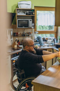 Side view of woman using mobile phone at cafe