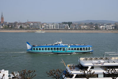 Boats in sea against clear sky