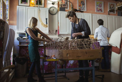 Female workers making chaise longue together at workplace