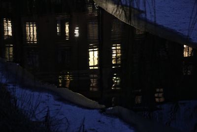 Illuminated building covered with snow at night