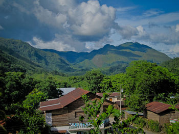 Scenic view of mountains and trees against sky