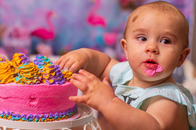 Close-up of cute baby girl eating frosting