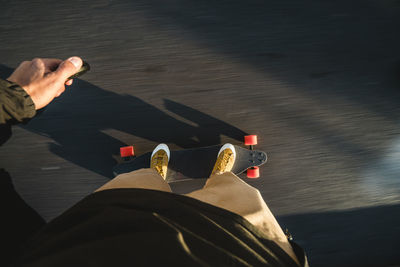 Low section of man skateboarding on road in city