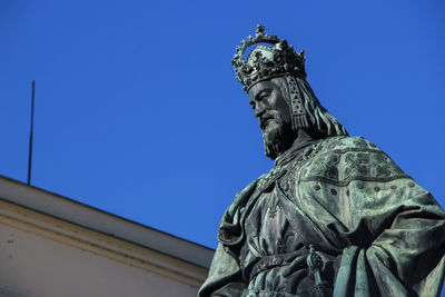 Low angle view of statue against blue sky