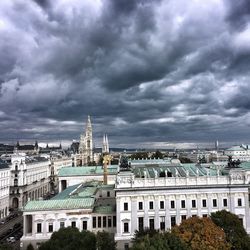 View of cityscape against cloudy sky