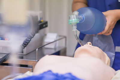 Cropped image of person learning cpr in hospital