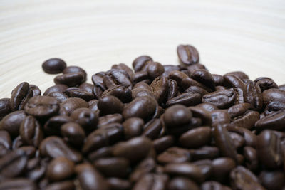 Close-up of coffee beans on wooden table