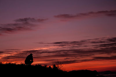 Silhouette landscape against sky during sunset