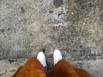 Low section of woman standing on concrete