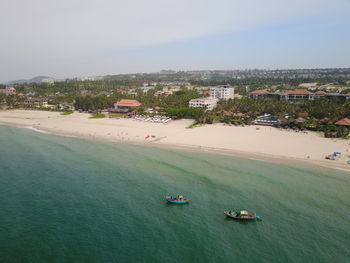 High angle view of sea and buildings against sky