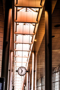 Low angle view of clock hanging to ceiling