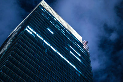 Low angle view of modern building against sky at night