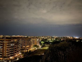 High angle view of illuminated buildings against sky