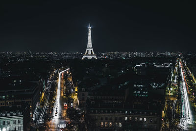 Illuminated cityscape against sky at night