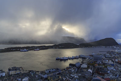 Panoramic view of sea and cityscape against sky