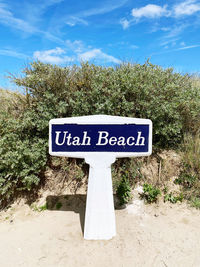 Low angle view of road sign against sky utah beach normandie plants trees sand beach travel holiday 