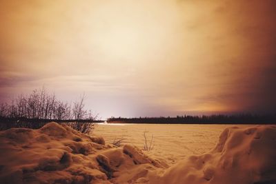 Scenic view of beach against sky during sunset