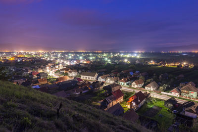 High angle view of illuminated buildings in city at night