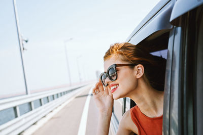 Portrait of young woman in car