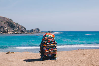 Deck chairs on beach against clear sky