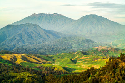 Scenic view of mountains against cloudy sky kawah ijen, banyuwangi - bondowoso, east java, indonesia