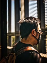 Rear view of man gazing out.