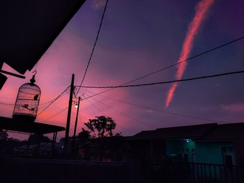 Low angle view of silhouette buildings against sky at sunset